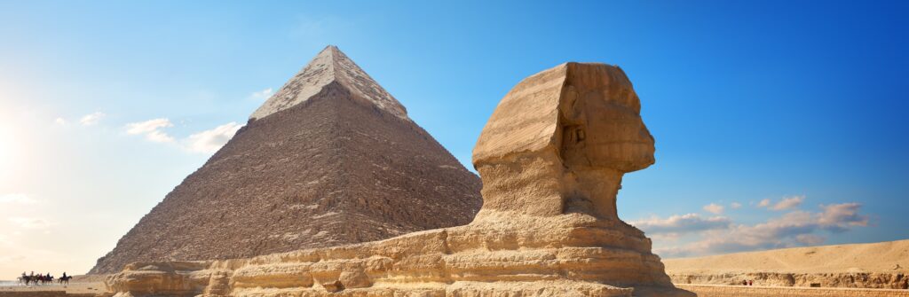 En bild på sfinxen och pyramiderna i Giza